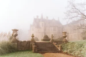 A foggy day at Orchardleigh House, with a castle in the background.