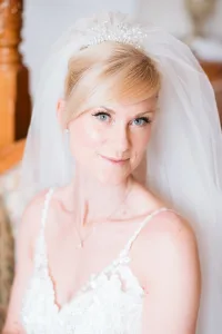 A beautiful bride wearing a wedding tiara poses for Orchardleigh House photos.