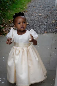 wedding photography A little girl in a dress walking down a wedding photography path.