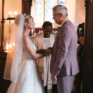 A bride and groom exchanging vows in a Orchardleigh House, captured in beautiful photos.