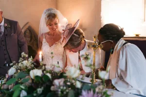 A couple exchanging their wedding vows in a church, captured in stunning Orchardleigh House photos.