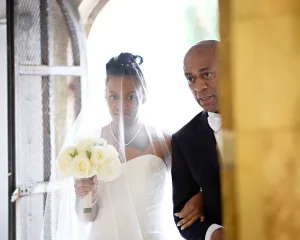 wedding photography Orchardleigh Wedding Photography captures the magical moment of a bride and groom gracefully walking through a doorway on their special day.
