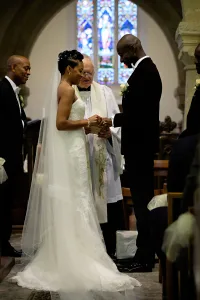 wedding photography Orchardleigh Wedding Photography captures a bride and groom exchanging their wedding rings in a church.