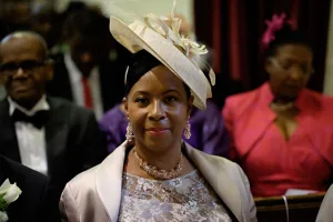wedding photography Orchardleigh Wedding Photography captures a stunning image of a woman donning a hat and tuxedo, exuding an elegant and unique style at a wedding.