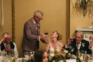 Orchardleigh House Photos capturing a bride and groom toasting at their wedding reception.