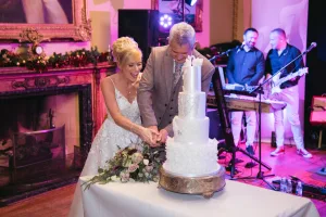 Orchardleigh House newlyweds cutting their wedding cake.