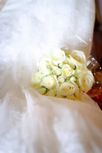 wedding photography Orchardleigh House wedding bouquet with white roses and photos.