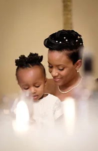wedding photography A Wedding Photographer captures a beautiful moment of a woman and her child sitting at a table in Orchardleigh.