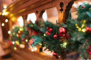 Orchardleigh House Christmas decorations on a wooden railing.