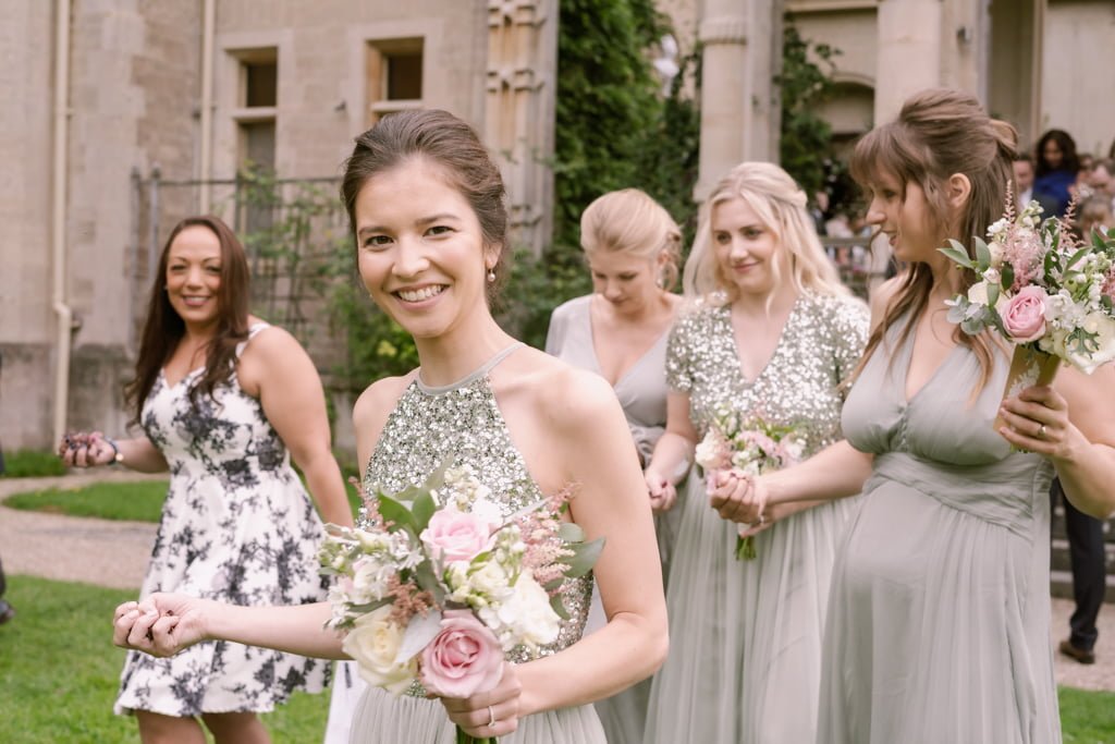 a group of bridesmaids standing in front of a building.