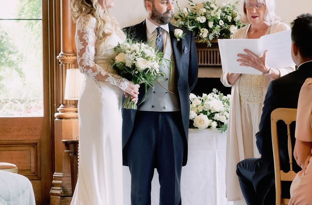 a man and a woman standing at a wedding ceremony.