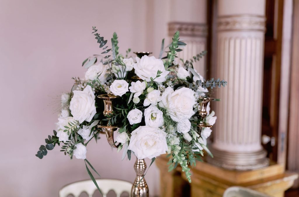 a vase filled with white flowers on top of a table.