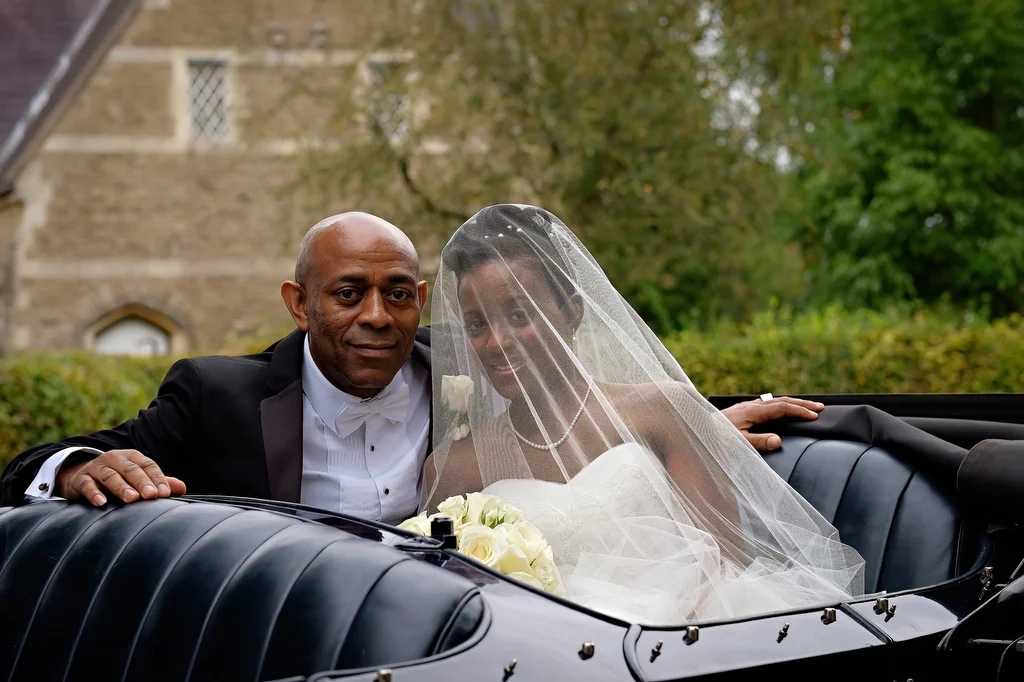 a man and a woman in a wedding car.