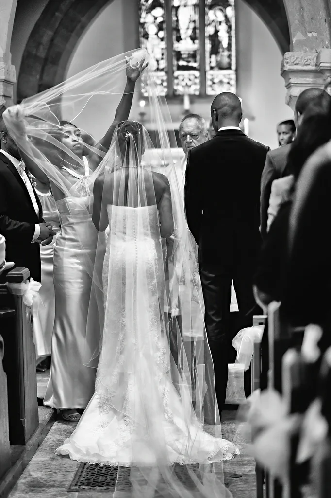 a bride and groom walking down the aisle of a church.