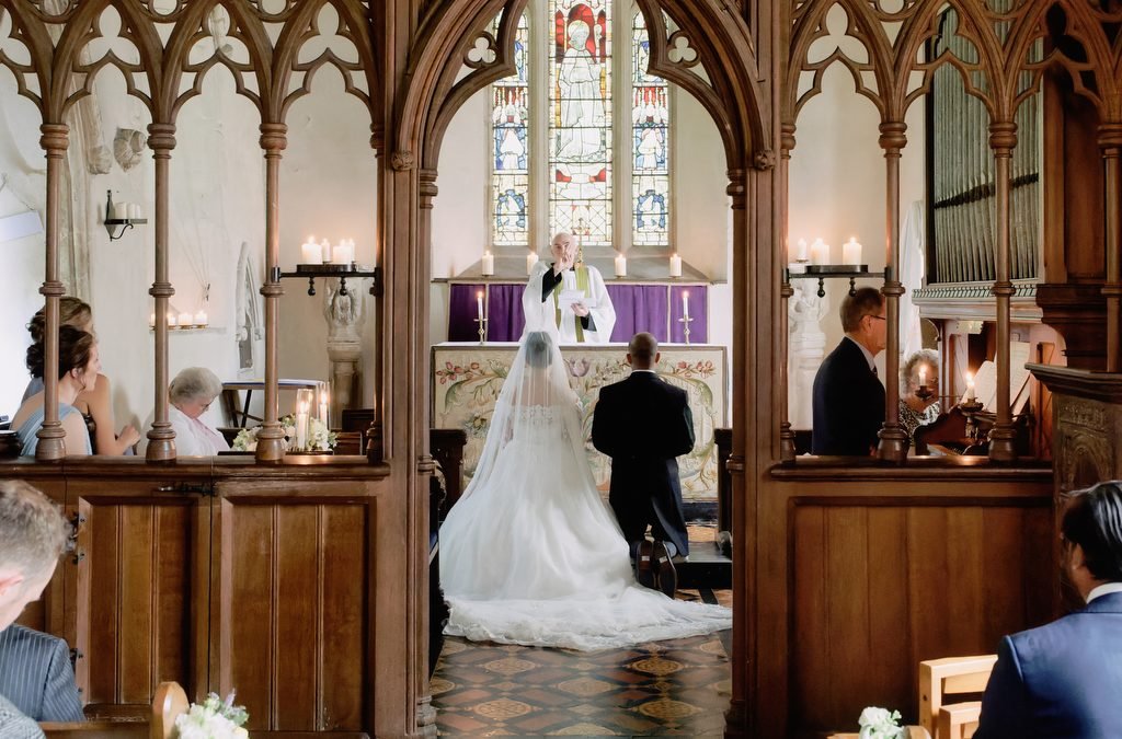a bride and groom walking down the aisle of a church.