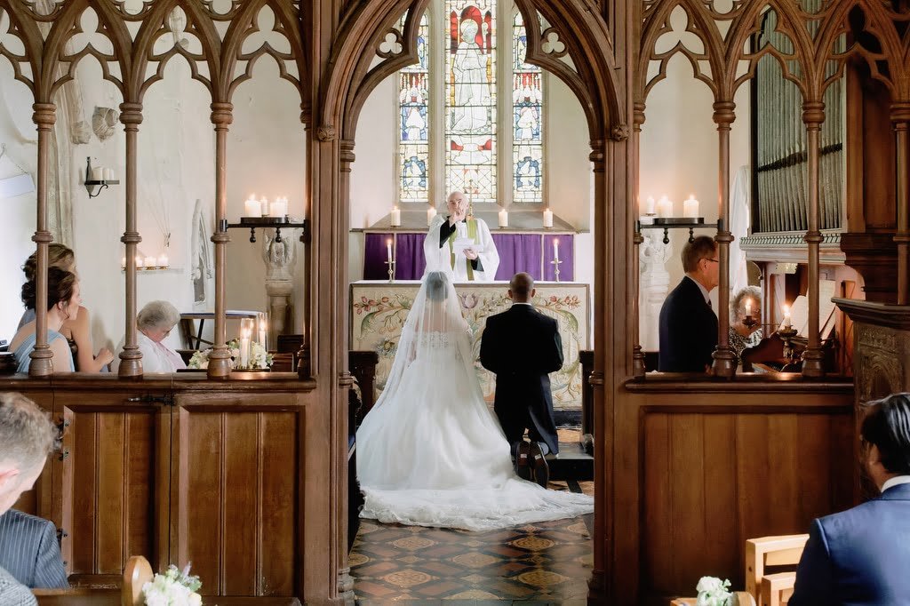 a bride and groom walking down the aisle of a church.