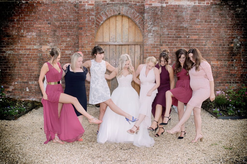 Wedding Gifts for Bridesmaids: a group of women in dresses posing for a picture.