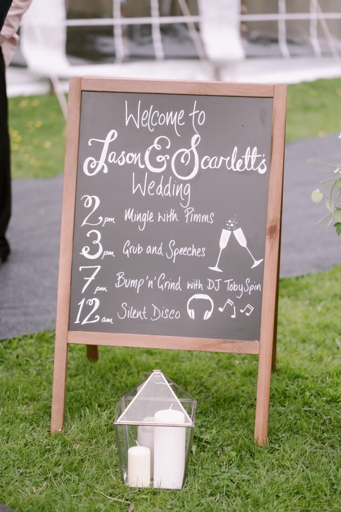 a welcome sign for a wedding with candles.