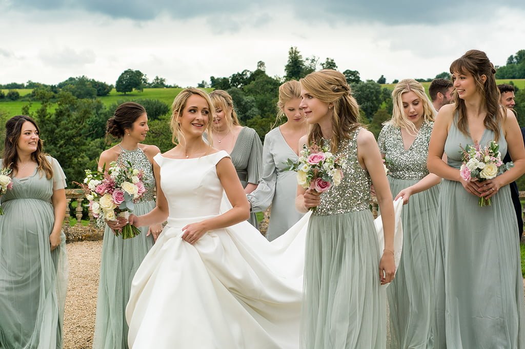 a group of bridesmaids are standing together.