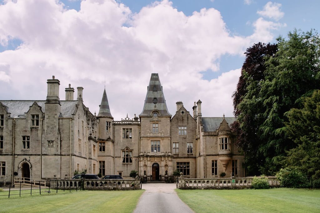 a large castle like building with a driveway in front of it.