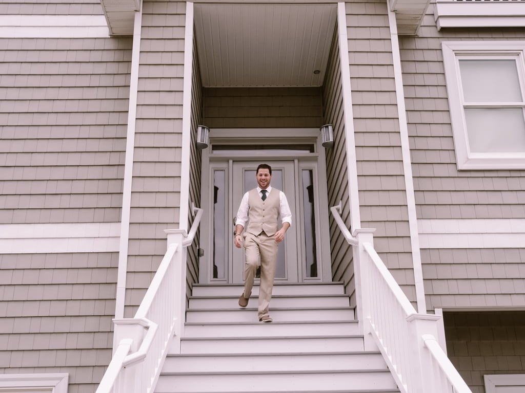a man in a suit walking down a set of stairs.