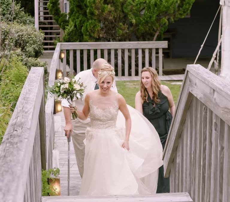 a bride and her mother walking down the stairs.
