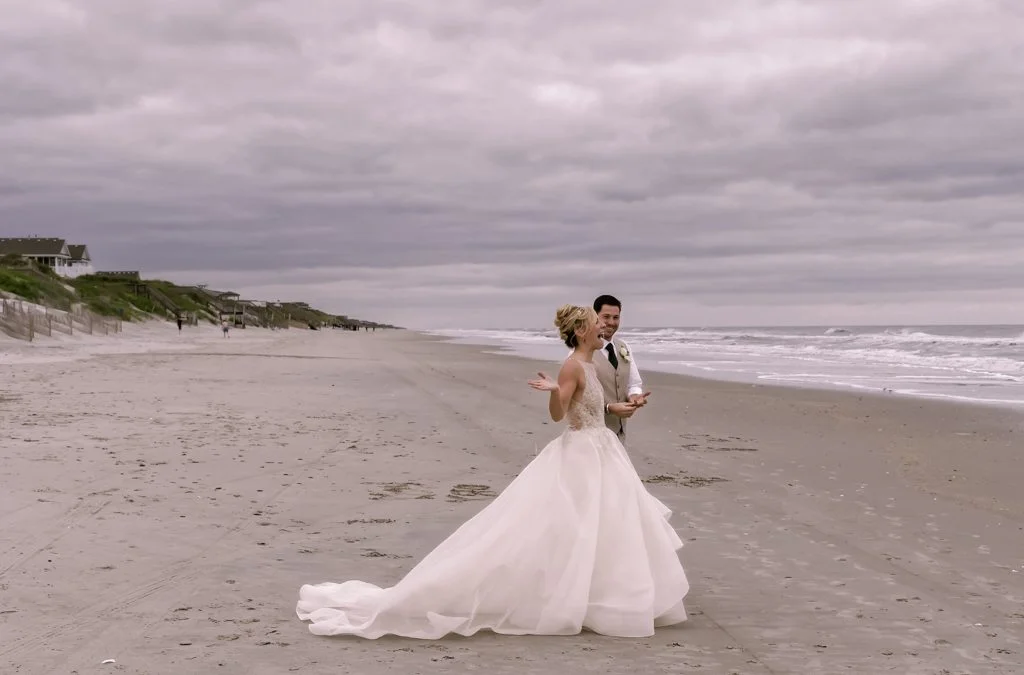 Documentary wedding photography.a bride and groom walking on the beach.