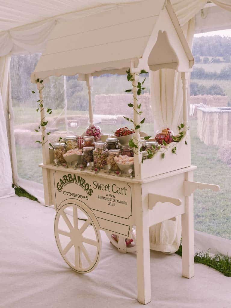 a white cart with a bunch of food on top of it.