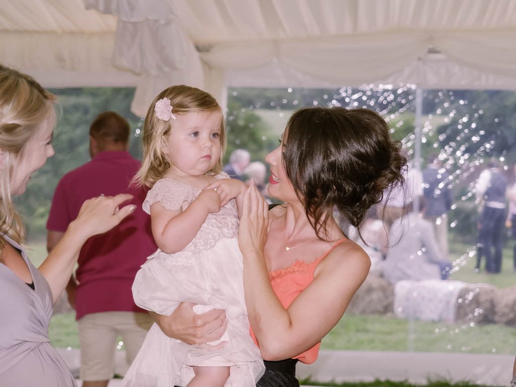 a woman holding a little girl in her arms.