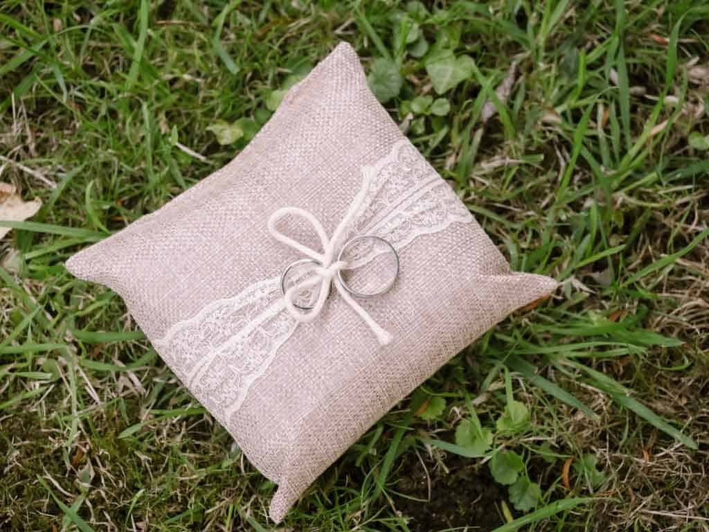 a small pillow on the ground with a bow on it.