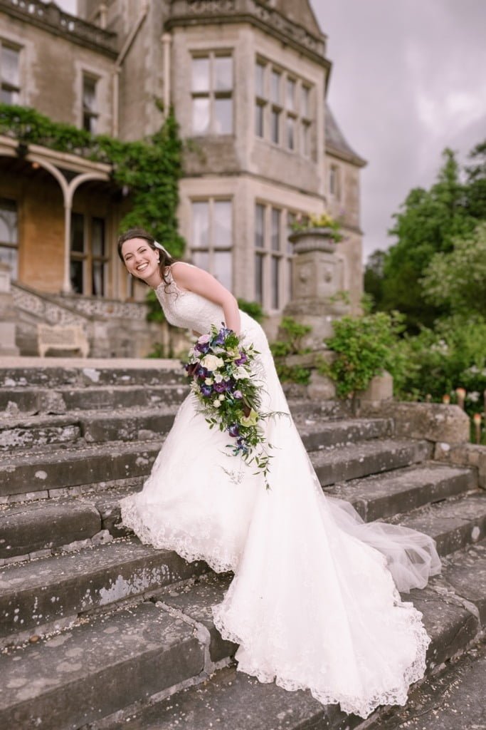 a woman in a wedding dress standing on some steps.