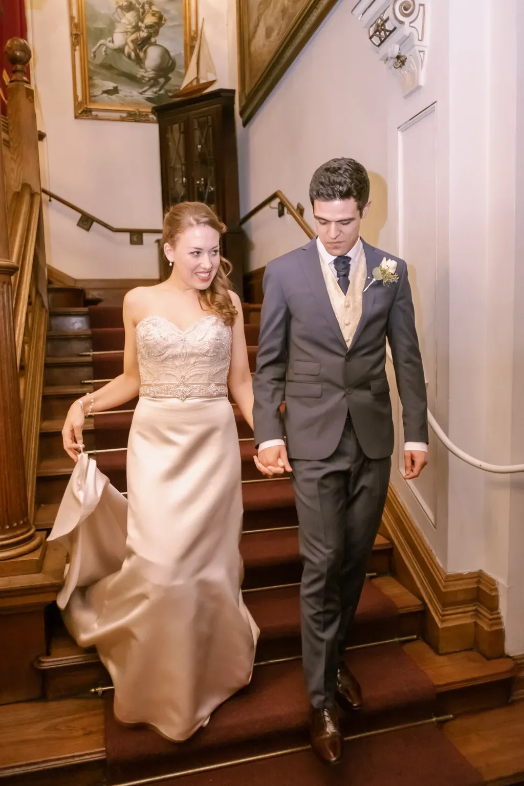 Orchardleigh Photo: a bride and groom walking down a flight of stairs.