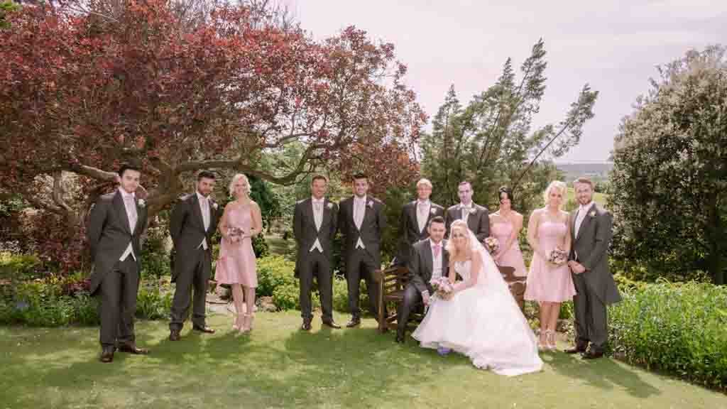 Wedding Guest Lists: a group of people standing next to each other on a lush green field Old Down Manor
