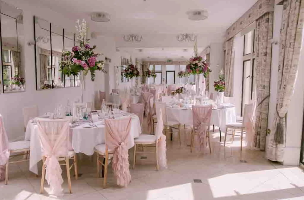 The City of bath:a room filled with tables and chairs covered in pink cloths at Old Down Wedding Estate