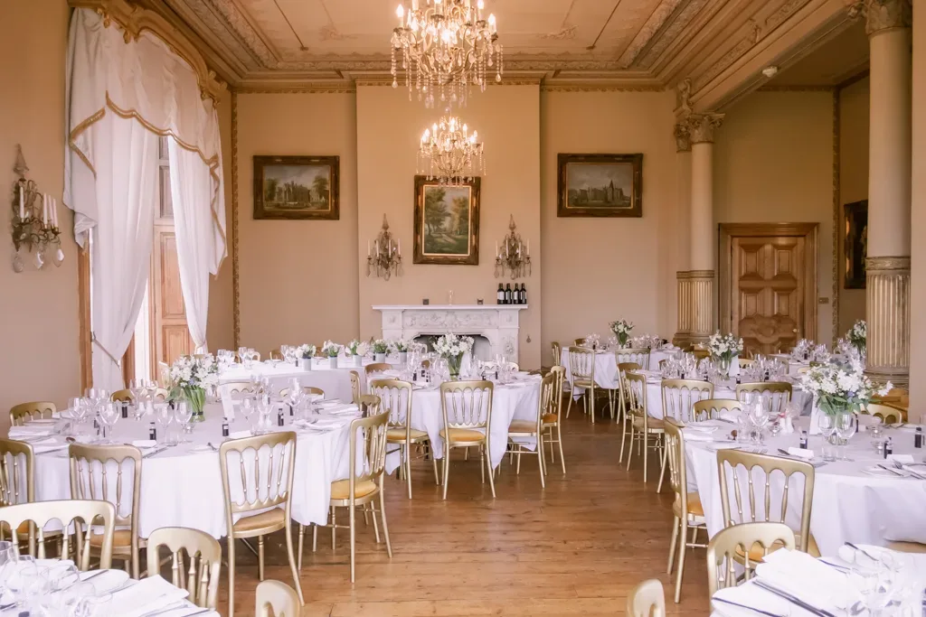 Orchardleigh House Reception Room: a room filled with tables and chairs covered in white tablecloths.