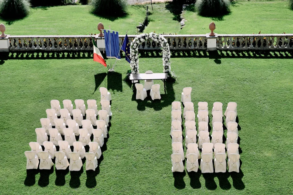Italian Wedding Venue: a group of chairs sitting on top of a lush green field.