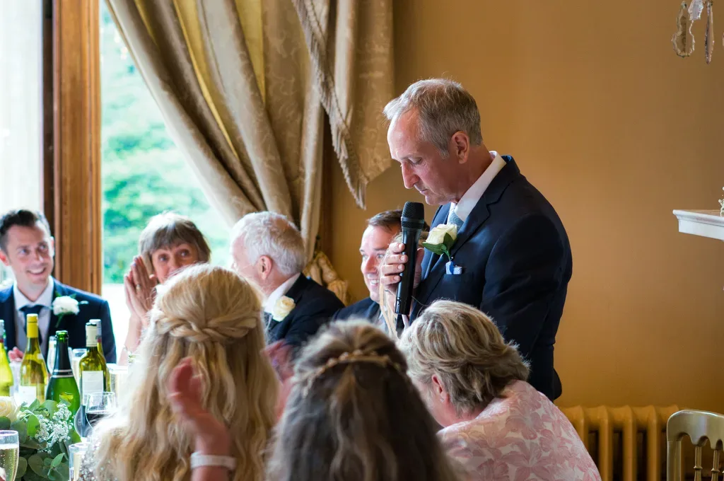 Father of the Bride speech: a man giving a speech to a group of people.