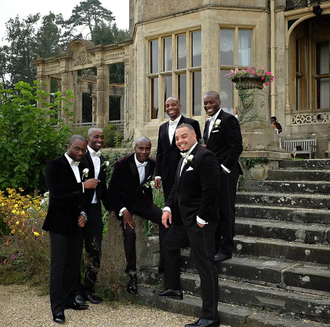Ushers t Orchardleigh House: a group of men in tuxedos standing in front of a building.
