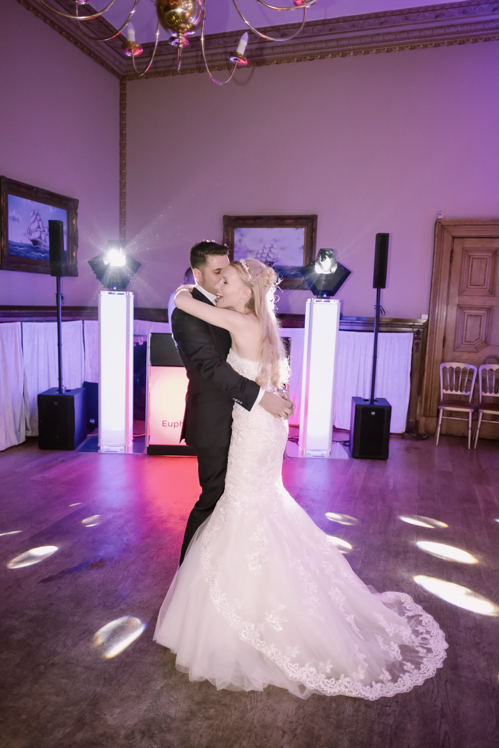 a bride and groom dance on the dance floor.