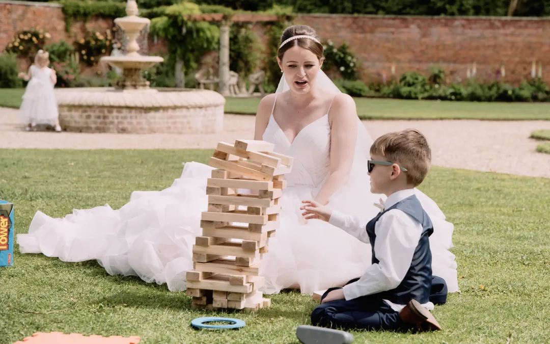 Planning your wedding day: a bride and a boy playing with a tower of blocks.