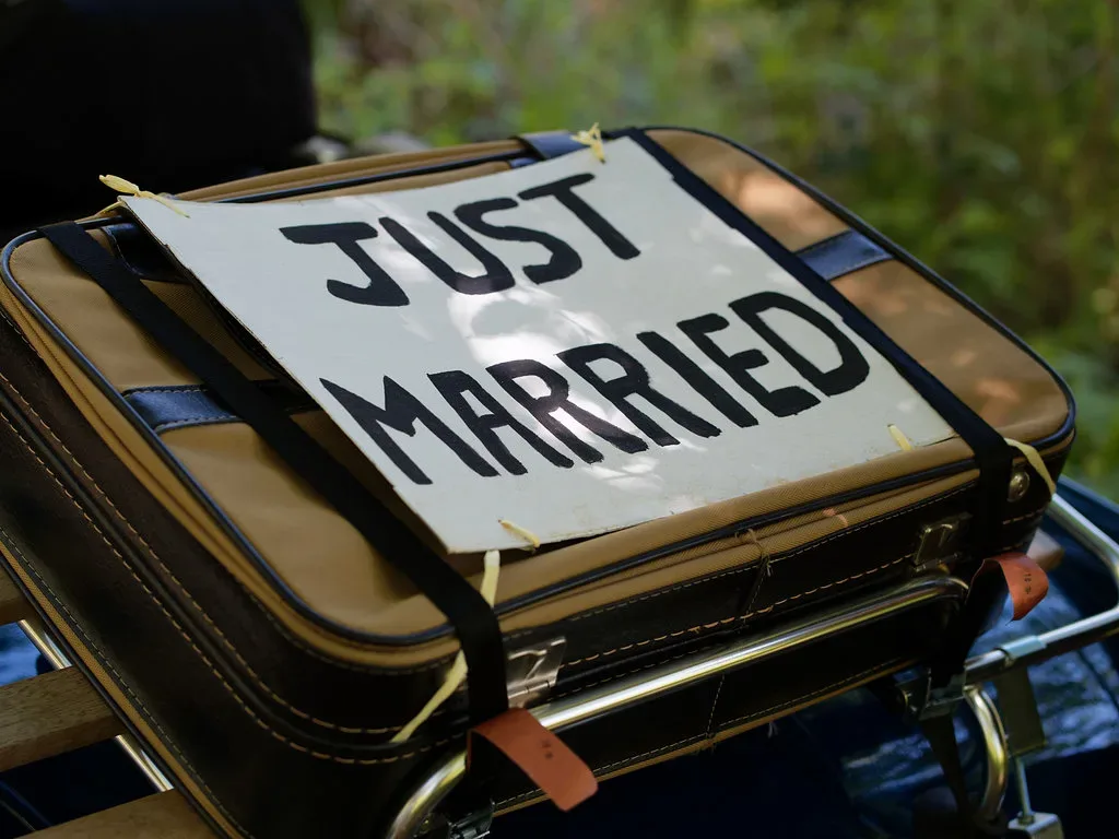 a suitcase with a sign that says just married. Elmhay Park