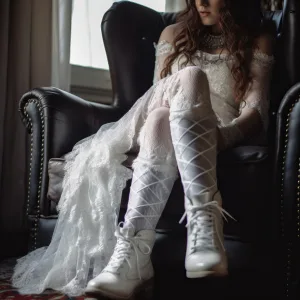Bride putting on her white lace boots at a wedding in Bath Avon UK