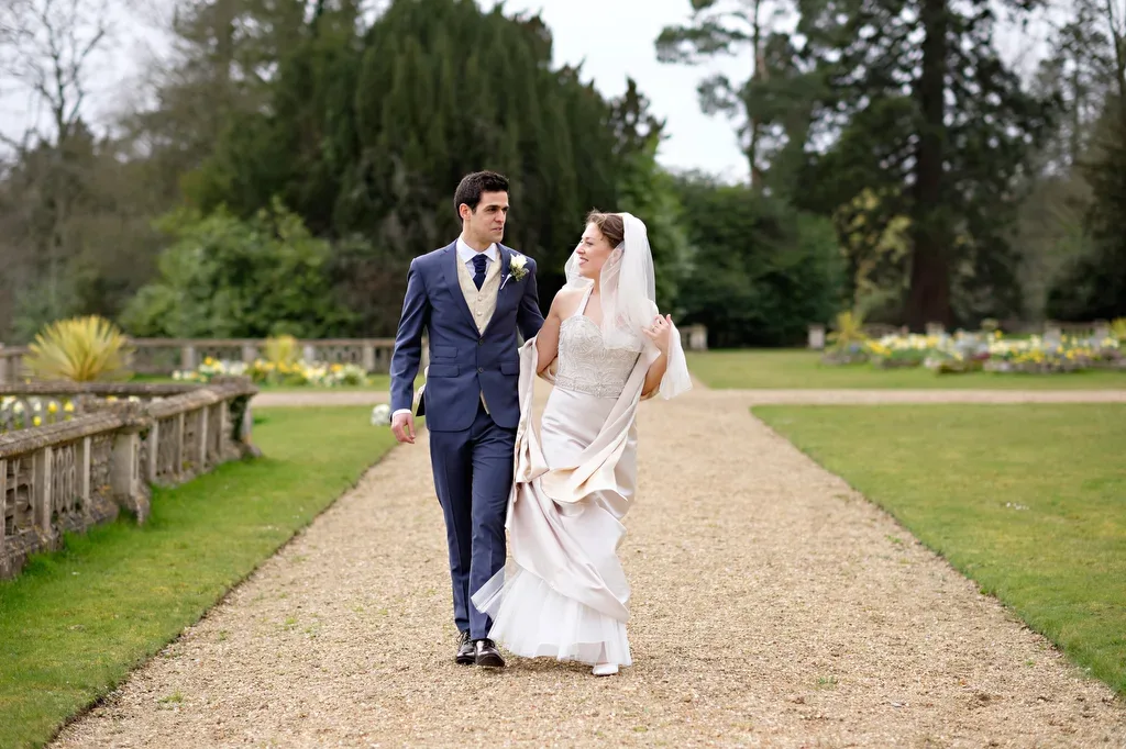 Orchardleigh House is Amazing: a bride and groom walking down a path.