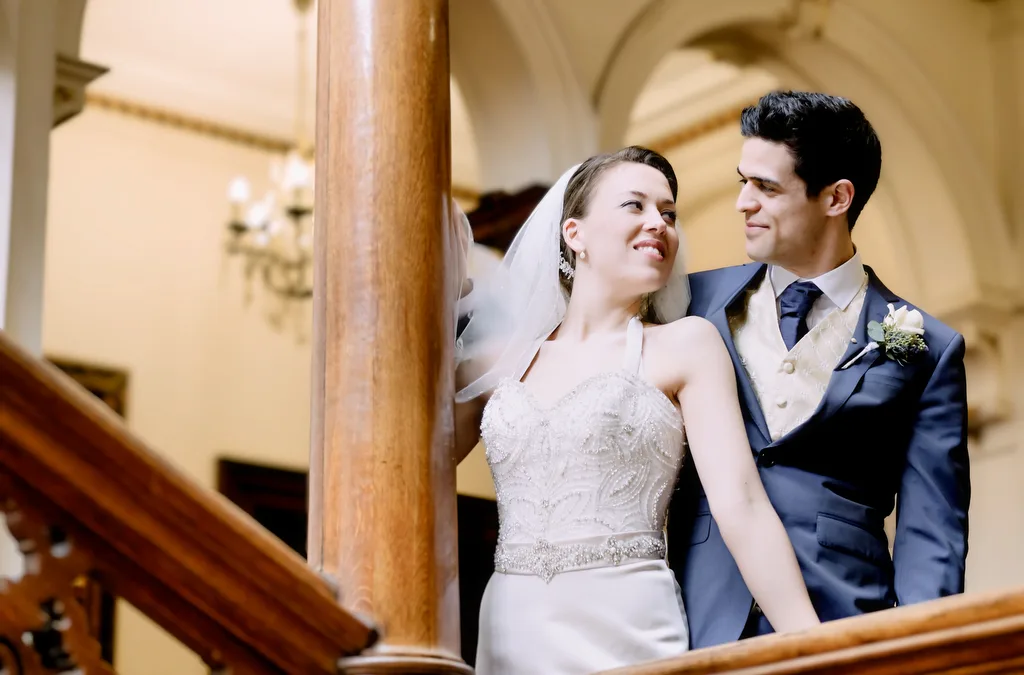 Award Winning: Amazing Orchardleigh:a bride and groom standing on a staircase.