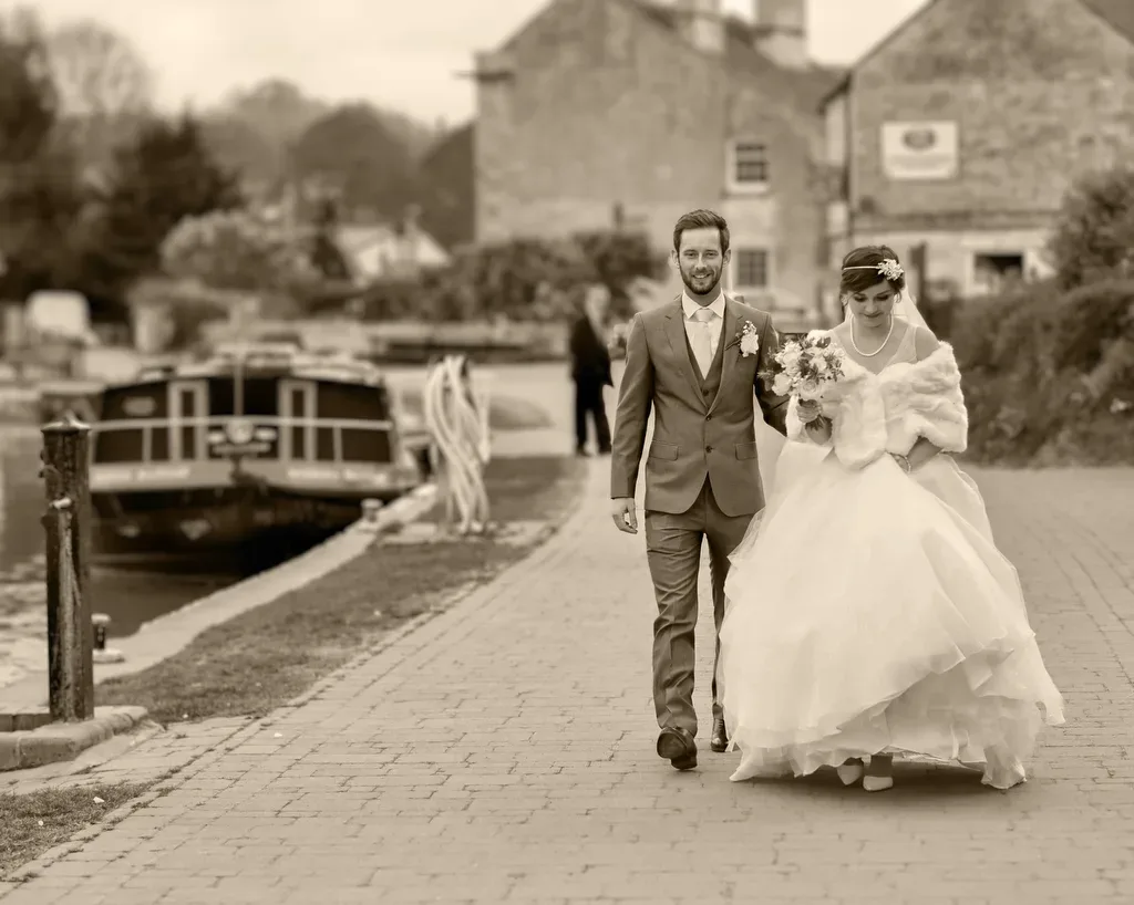 Married in Frome: a bride and groom are walking down the street.
