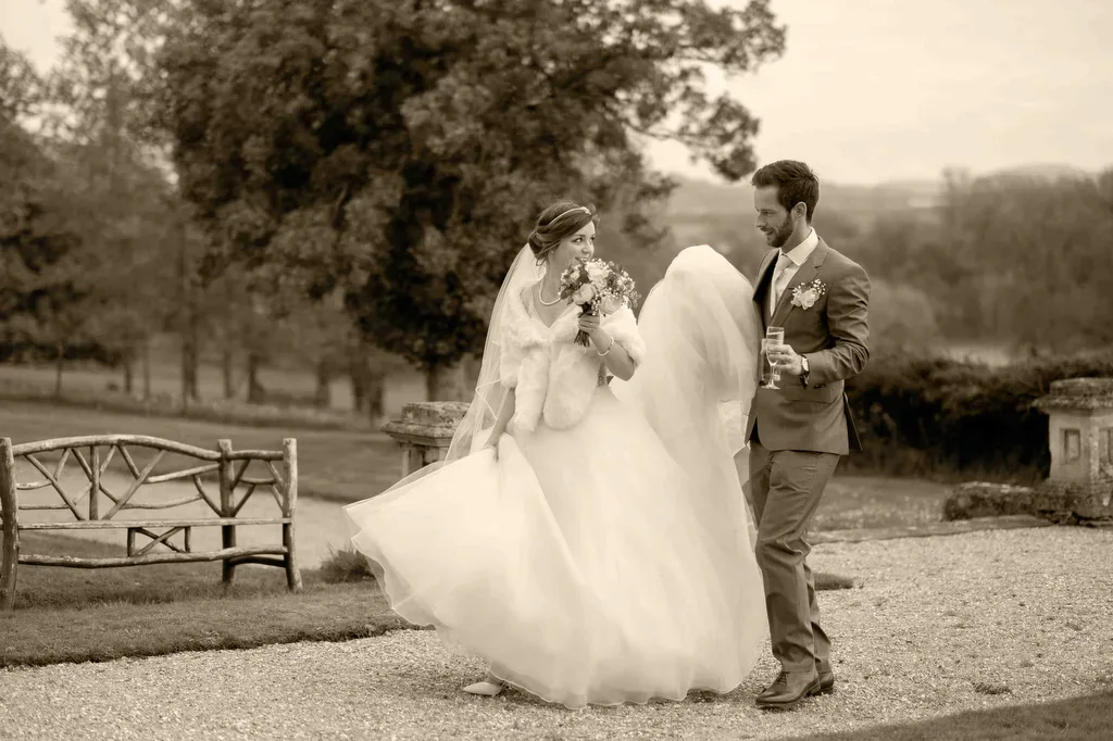 We got married in Frome:a bride and groom walking together in a park near Wick Farm Bath