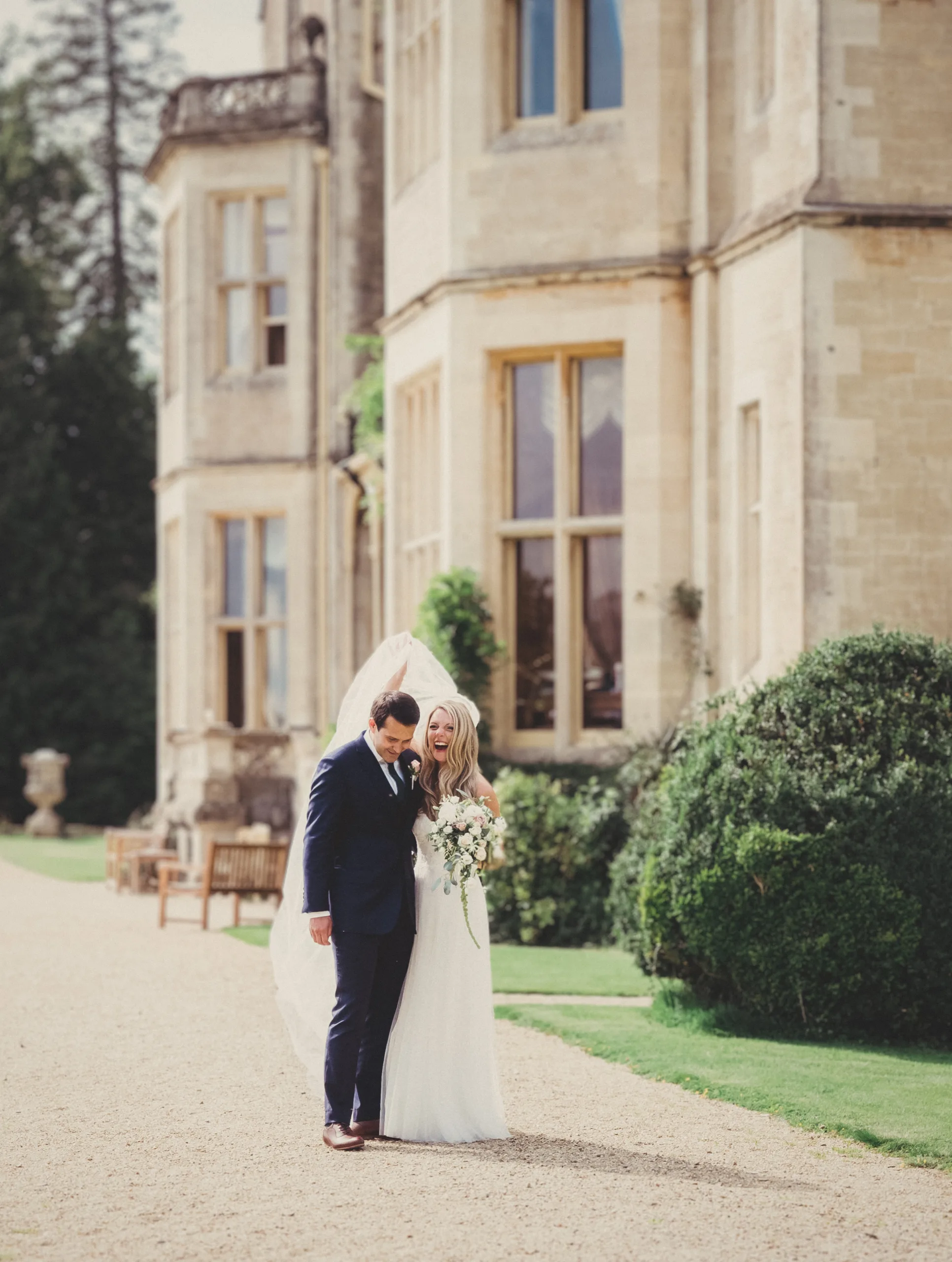 uk marriages :a bride and groom standing in front of a large building.