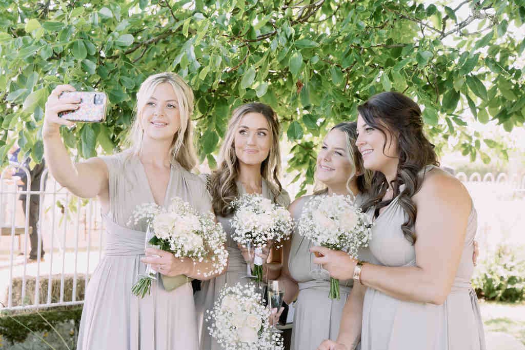 a group of women standing next to each other. Seymours Court by Local Wedding Photographer
