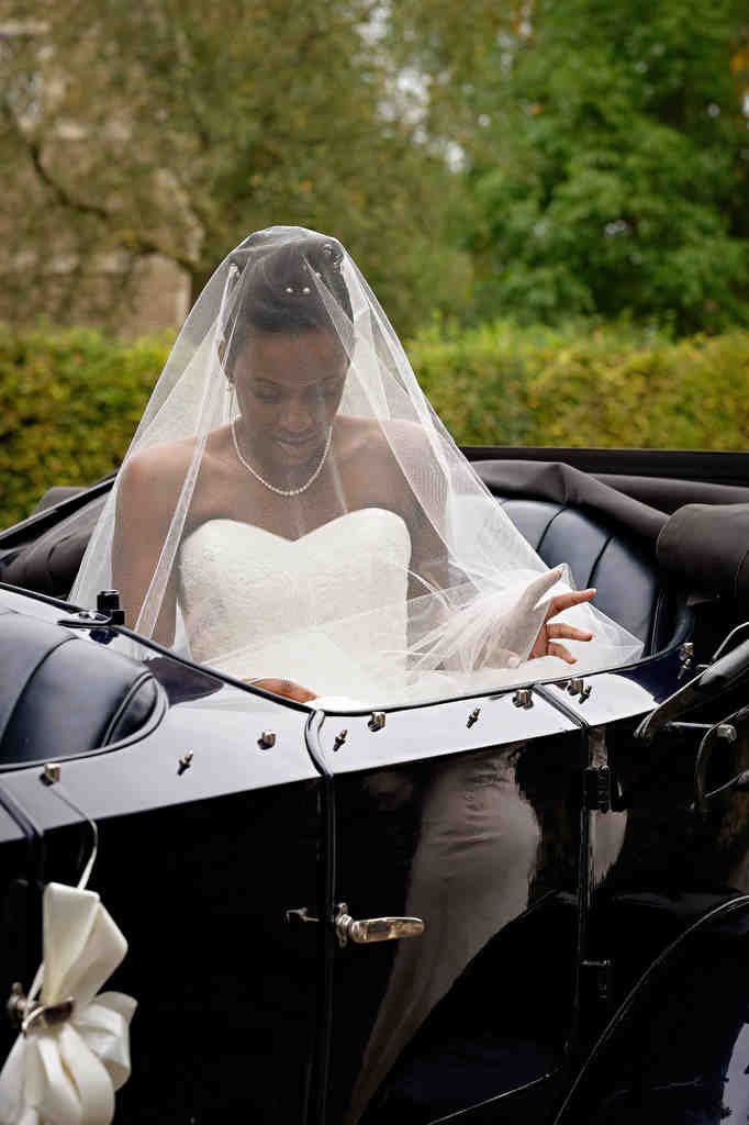 a woman in a wedding dress is riding in a horse drawn carriage. Bath Spa Wedding Photography Offer