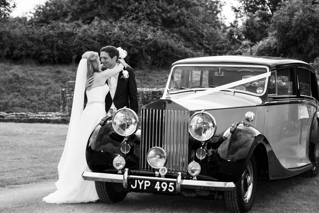 Bath Weddings: Wick Farm Wedding Photographer: a bride and groom standing next to a vintage car.